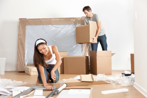 Removal team sorting cardboard and reusable packing materials for recycling in Aberdeen