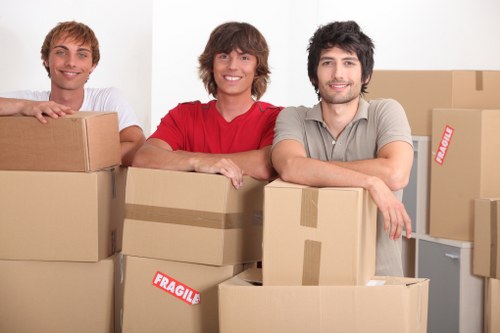 Packed moving boxes and protected furniture ready for house removals
