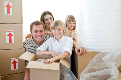Local movers handling furniture in a city apartment move